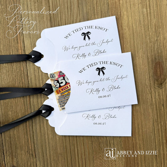 Fun wedding favors personalized, 'we tied the knot we hope you hit the jackpot'.  Lottery ticket wedding favors, slide a scratch off in the open end and see who wins.  Personalized for the bride and groom with your choice of ribbon  colors.
