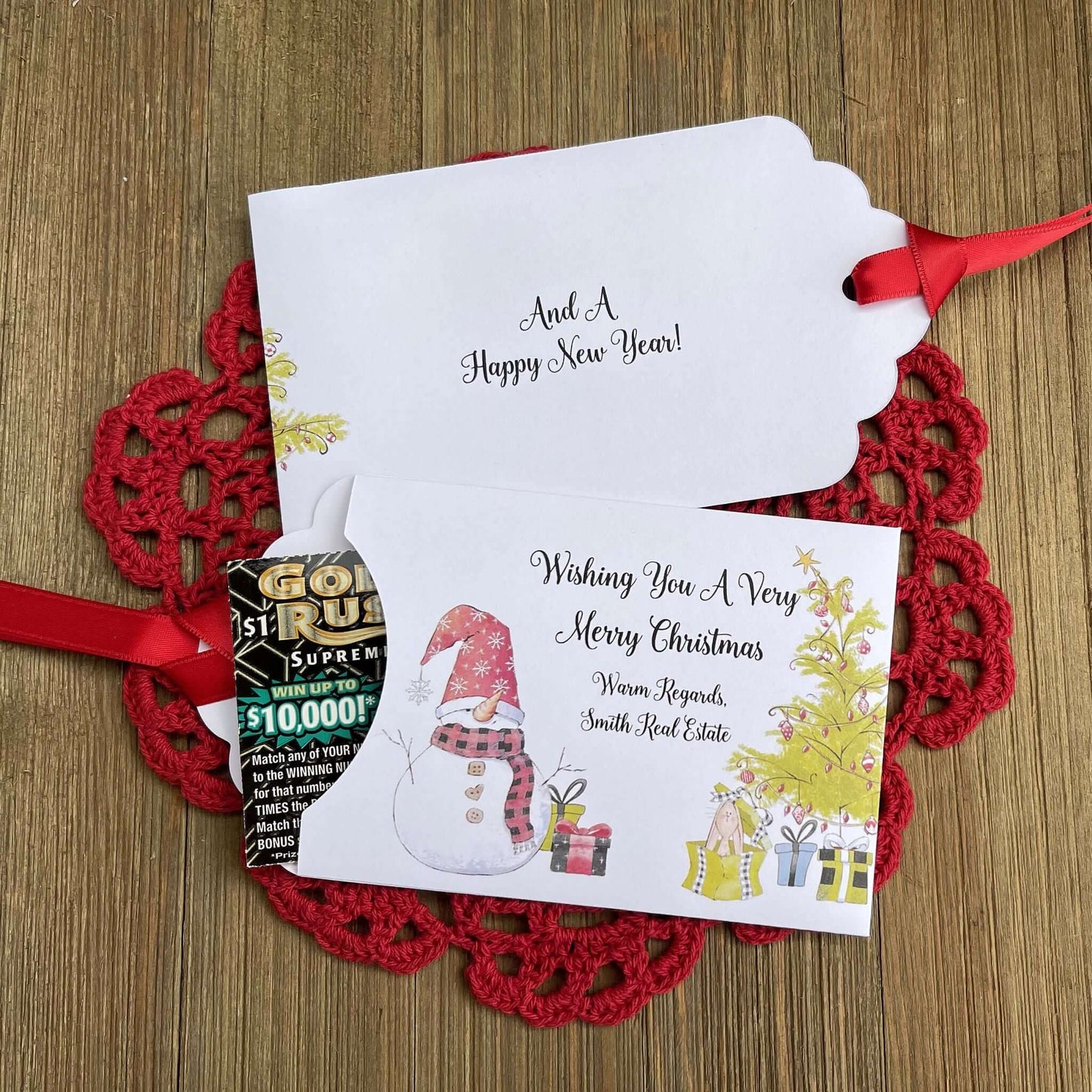 Small Christmas gift Lottery Ticket Envelopes featuring a snowman design and red ribbon, perfect for holiday gifting.