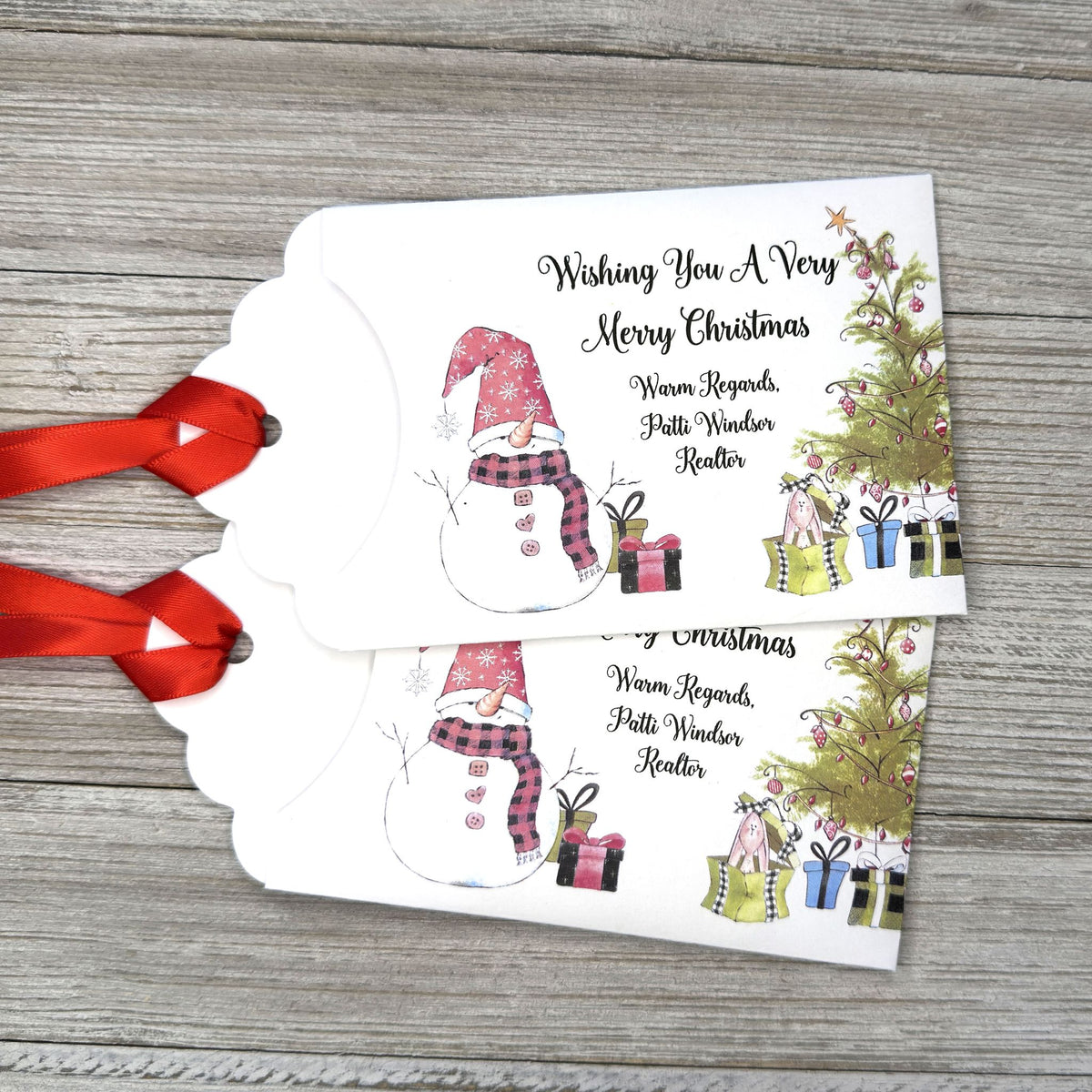 Small Christmas gift lottery ticket envelopes, give your guests a chance to win big. Enclose a scratch off lotto ticket, just a little something to remember friends or co-workers this Holiday Season.  Envelopes are made from white cardstock with a snowman, Christmas tree and gifts.  Personalized with wishing you a Very Merry Christmas. Red ribbon comes attached.