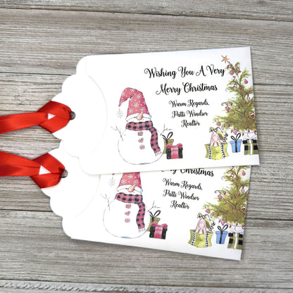 Small Christmas gift lottery ticket envelopes, give your guests a chance to win big. Enclose a scratch off lotto ticket, just a little something to remember friends or co-workers this Holiday Season.  Envelopes are made from white cardstock with a snowman, Christmas tree and gifts.  Personalized with wishing you a Very Merry Christmas. Red ribbon comes attached.