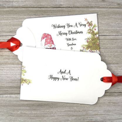 Small Christmas gift lottery ticket envelopes, give your guests a chance to win big. Enclose a scratch off lotto ticket, just a little something to remember friends or co-workers this Holiday Season.  Envelopes are made from white cardstock with a snowman, Christmas tree and gifts.  Personalized with wishing you a Very Merry Christmas. Red ribbon comes attached.