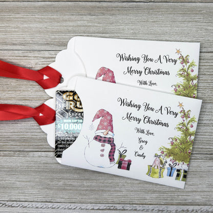 Small Christmas gift lottery ticket envelopes, give your guests a chance to win big. Enclose a scratch off lotto ticket, just a little something to remember friends or co-workers this Holiday Season.  Envelopes are made from white cardstock with a snowman, Christmas tree and gifts.  Personalized with wishing you a Very Merry Christmas. Red ribbon comes attached.