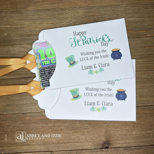 Personalized St Patrick's Day Party Favors, 'Happy St. Patrick's Day, wishing you the LUCK of the Irish'.  Printed on white card stock, adorned with a green hat, pot of gold and gold ribbon attached.  Slide a lottery ticket in the open end and see who has the LUCK of the Irish.