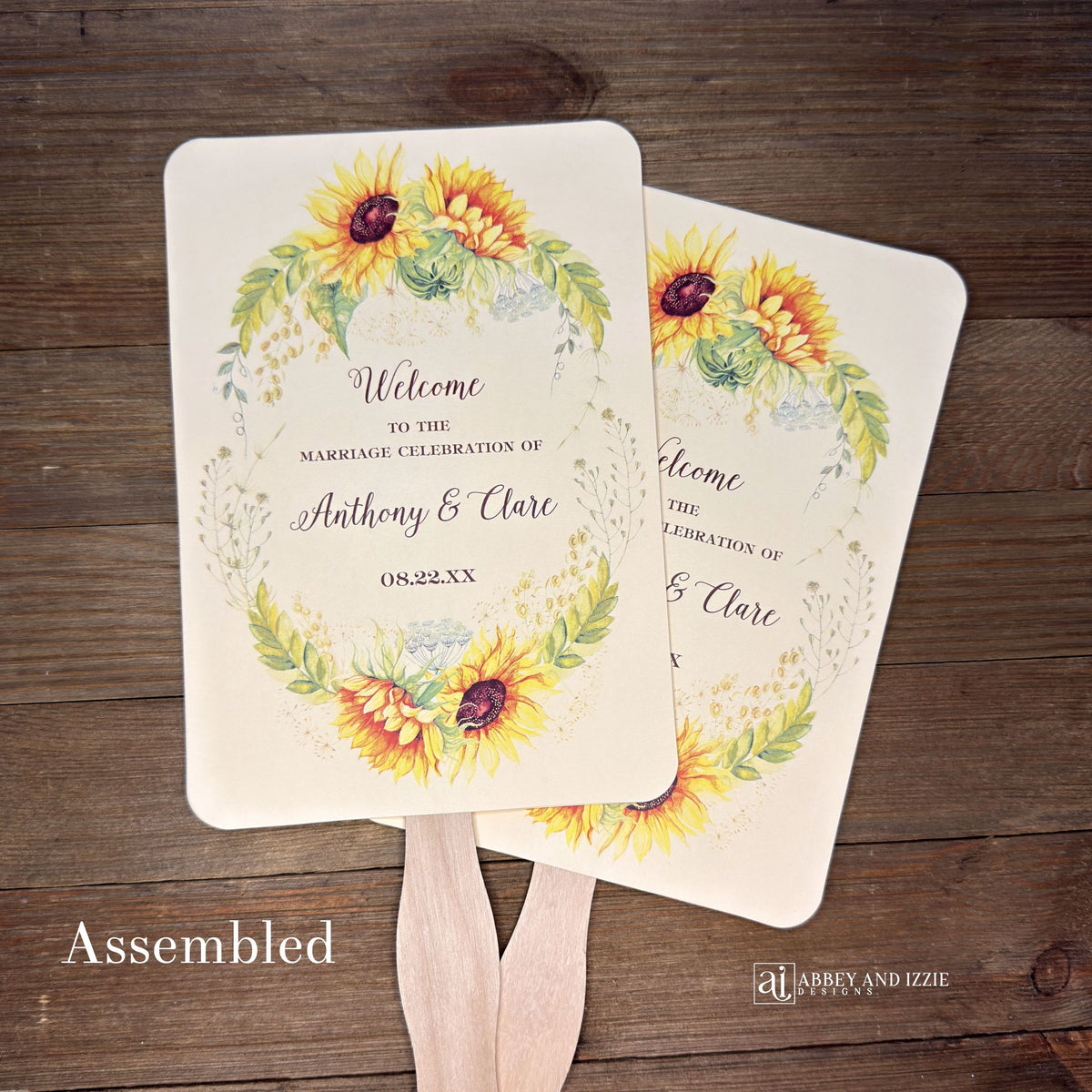 Sunflower Wedding Hand Fans Personalized , personalized for the bride and groom and adorned with a ring of sunflowers.  Fans are printed on ivory or white cardstock, two sided so handle is hidden between.  Wedding fans ship fully assembled and ready for your big day.