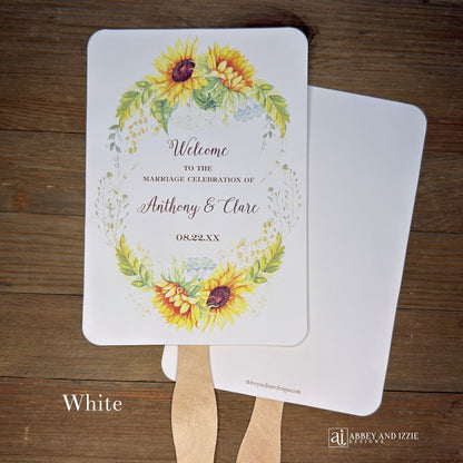Sunflower Wedding Hand Fans Personalized , personalized for the bride and groom and adorned with a ring of sunflowers.  Fans are printed on ivory or white cardstock, two sided so handle is hidden between.  Wedding fans ship fully assembled and ready for your big day.
