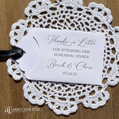 Our Scratch off Lotto Rehearsal Dinner Favors are sure to be a hit.  White envelopes printed with 'Thanks a lotto for attending our rehearsal dinner' with bride and grooms names and date.  Slide a lottery ticket in these white envelopes to see who wins.  Ribbon comes attached, your choice of color.