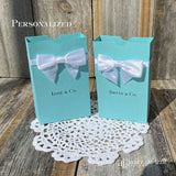 Tiffany & co. favor boxes personalized for the guest of honor.  Boxes feature white ribbon around the top adorned with a white box.  Great for candy or any sweet treat.  