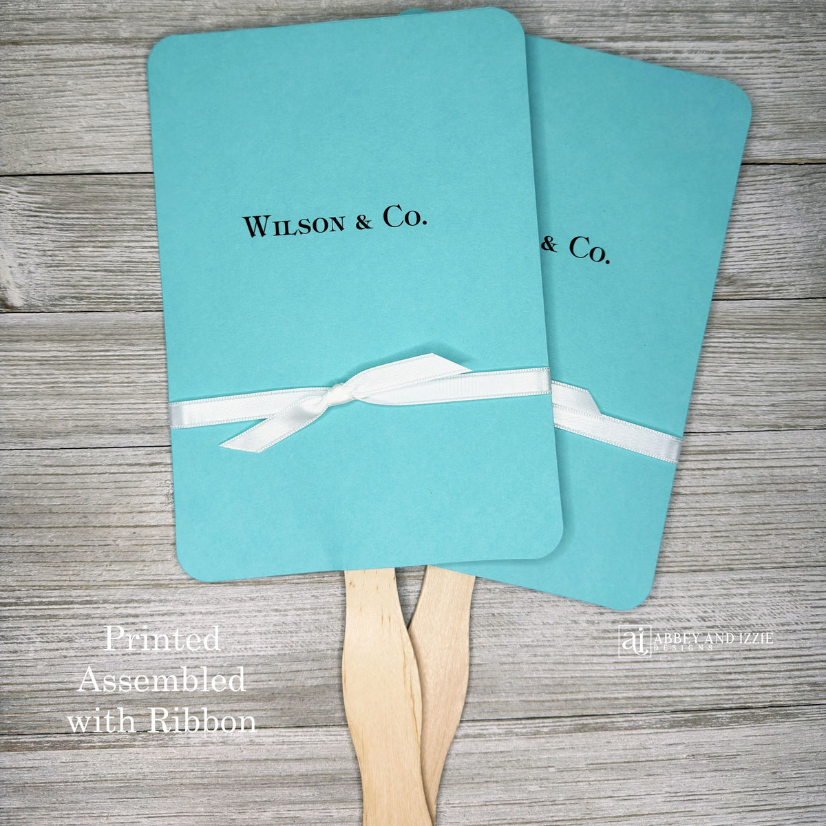 An elegant take on the hand fan , these Aqua Wedding Fans with Ribbon are sure to be appreciated on that hot sunny day.  Personalized with couples last name & Co.  White ribbon is included and comes attached.  Fans for Tiffany.