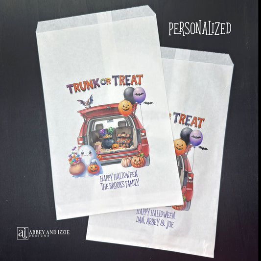 Personalize your trunk-or-treat celebration bags, make each trick-or-treater feel special. These durable, treat bags feature 'Happy Halloween' and your names, perfect for neighborhood events, school celebrations, or family gatherings.  Printed on white paper bags with Trunk or Treat at the top, a car with back open for the event.  Filled with cute Halloween decorations.  
