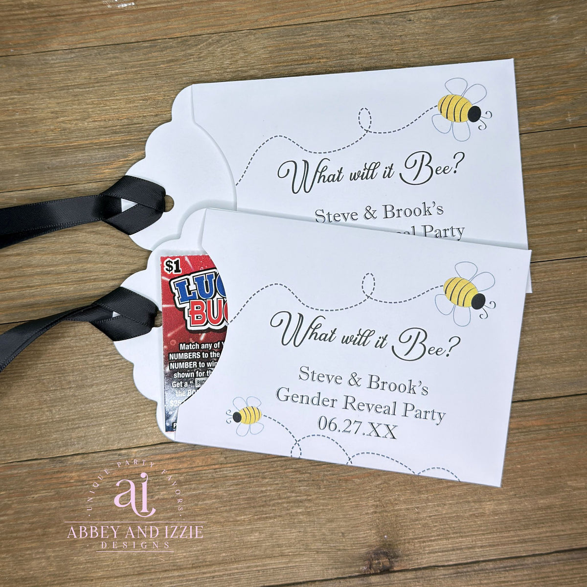 Celebrate the big reveal with these charming "What will it Bee?" gender reveal favors.  Slide a scratch off ticket inside these envelopes for some exciting favors.  White cardstock envelopes with black ribbon attahced adorned with cute bees and personalized for the parents to be.