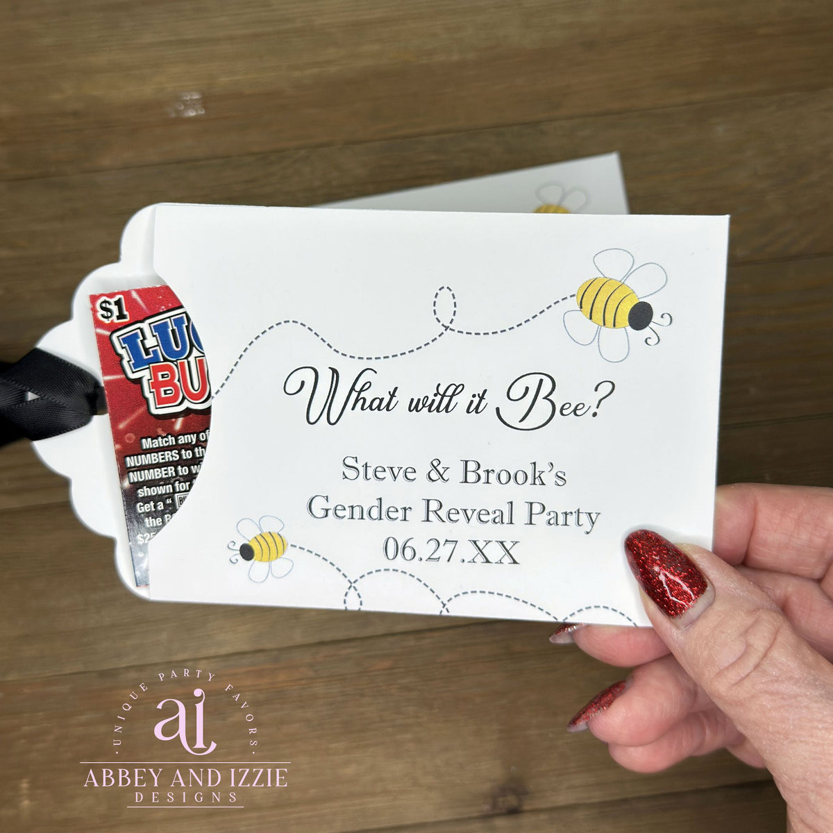 Celebrate the big reveal with these charming "What will it Bee?" gender reveal favors.  Slide a scratch off ticket inside these envelopes for some exciting favors.  White cardstock envelopes with black ribbon attahced adorned with cute bees and personalized for the parents to be.