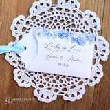 Our blue hydrangea wedding favors are made from white cardstock, adorned with delicate hydrangeas at the top, printed with 'Lucky In Love' with the brdie and grooms names and wedding date.  Each comes with a light blue ribbon attached for an elegant touch.  Guest will find these lotto favors fun with hopes of winning something big.  