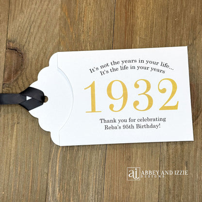 Personalized scratch-off birthday favors for adults. Each envelope features a special message with the year the guest of honor was born in color. Including a thank you for celebrating with the us. Works for milestone birthdays, adult parties, and special events see our store for more options. Constructed from white high-quality cardstock with your choice of year color and ribbon color, which comes attached.