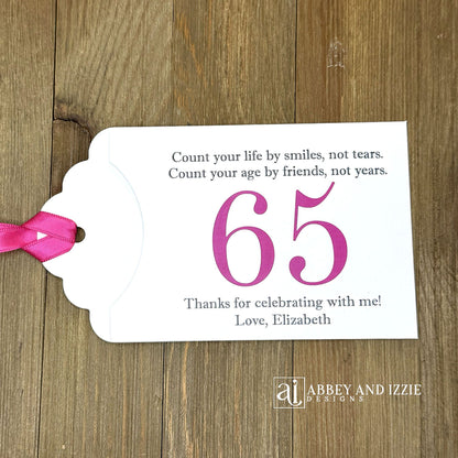 Celebrate with milestone birthday party guest favors that they will treasure. Each favor is customized with names, dates and a special messages to make your event unforgettable. Perfect for 30th, 40th, 50th, and beyond—these keepsakes add a personal touch to any milestone celebration.&nbsp; &nbsp;Printed on white cardstock with your choice of large number and ribbon color to match your party theme.