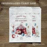 White circus theme birthday party favor bags personalized for the guest of honor.  Each is adorned with the big top tent, animals, balls and carnival fun.  Bags are larger then most and wil accomodate sweets, cookies, popcorn, peanuts.  