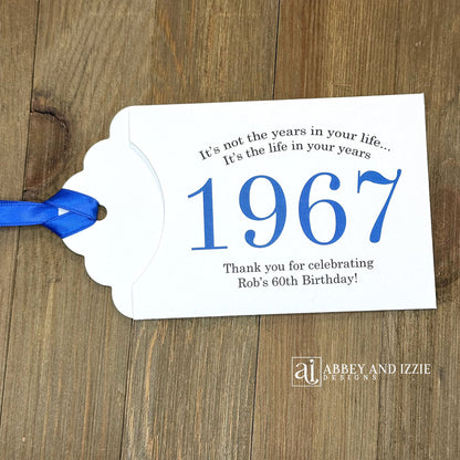 Personalized scratch-off birthday favors for adults. Each envelope features a special message with the year the guest of honor was born in color. Including a thank you for celebrating with the us. Works for milestone birthdays, adult parties, and special events see our store for more options. Constructed from white high-quality cardstock with your choice of year color and ribbon color, which comes attached.