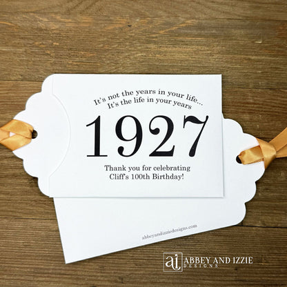 Our 100th birthday party favors are personalized for the guest of honor, your choice of ribbon color and year color. Always a fun ice breaker, slide a scratch off ticket in and see who is the winner! Each 100th birthday favor comes with the year the honoree was born printed in the center with 'It's not the years in your life...it's the life in your years' and happy birthday to the guest of honor. These can be made for any birthday year, 50th, 60th, 70th, 100th your choice. 100th Birthday Party Favors