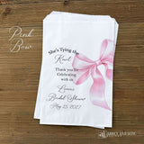 Send your guests home with a memorable keepsake from the bride-to-be's special day with our She's Tying the Knot Bridal Shower Favor Bags . These charming favor bags feature a playful "She's Tying the Knot" design that perfectly captures the excitement of bridal shower celebrations.  Adorned with a black or Pink bow, your choice and personalized for the bride to be.  Printed on white bags, larger than most.