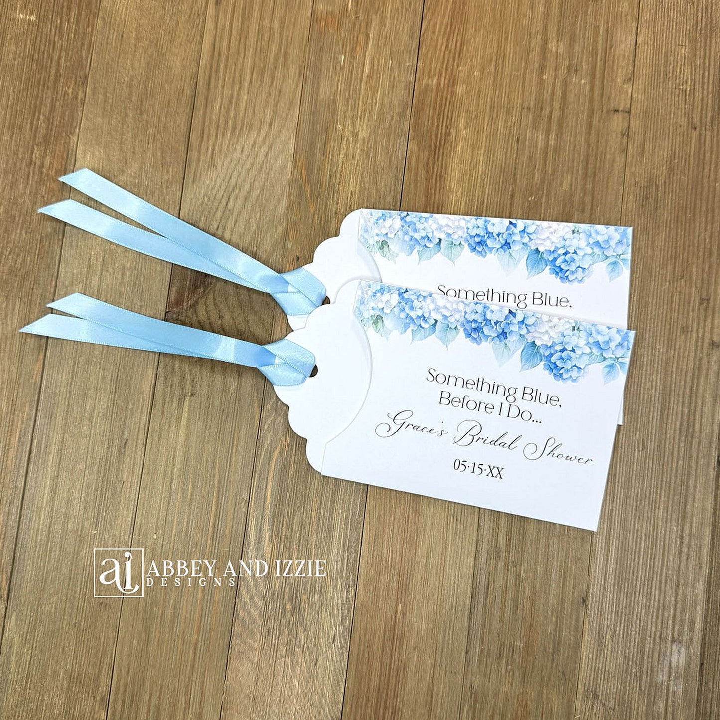Celebrate the bride-to-be with our Something Blue Bridal Shower Favors—a charming way to honor tradition while delighting your guests. Each favor features beautiful blue hydrangeas, perfect for that 'something blue before I say I do theme'. Personalize with name and date to create a keepsake your guests will treasure. Slide a scratch off card in the open end to add some excitement to the event. Printed on sturdy white card stock with blue ribbon attached. Ideal for adding an elegant touch.