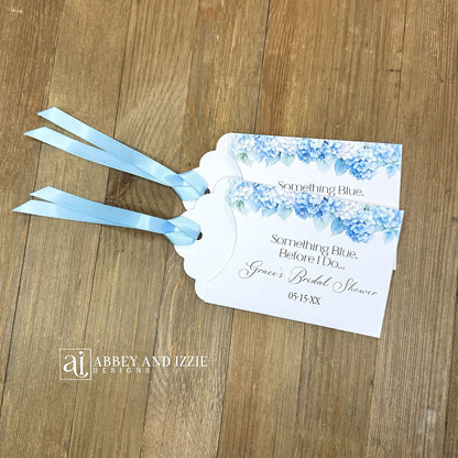 Celebrate the bride-to-be with our Something Blue Bridal Shower Favors—a charming way to honor tradition while delighting your guests. Each favor features beautiful blue hydrangeas, perfect for that 'something blue before I say I do theme'. Personalize with name and date to create a keepsake your guests will treasure. Slide a scratch off card in the open end to add some excitement to the event. Printed on sturdy white card stock with blue ribbon attached. Ideal for adding an elegant touch.