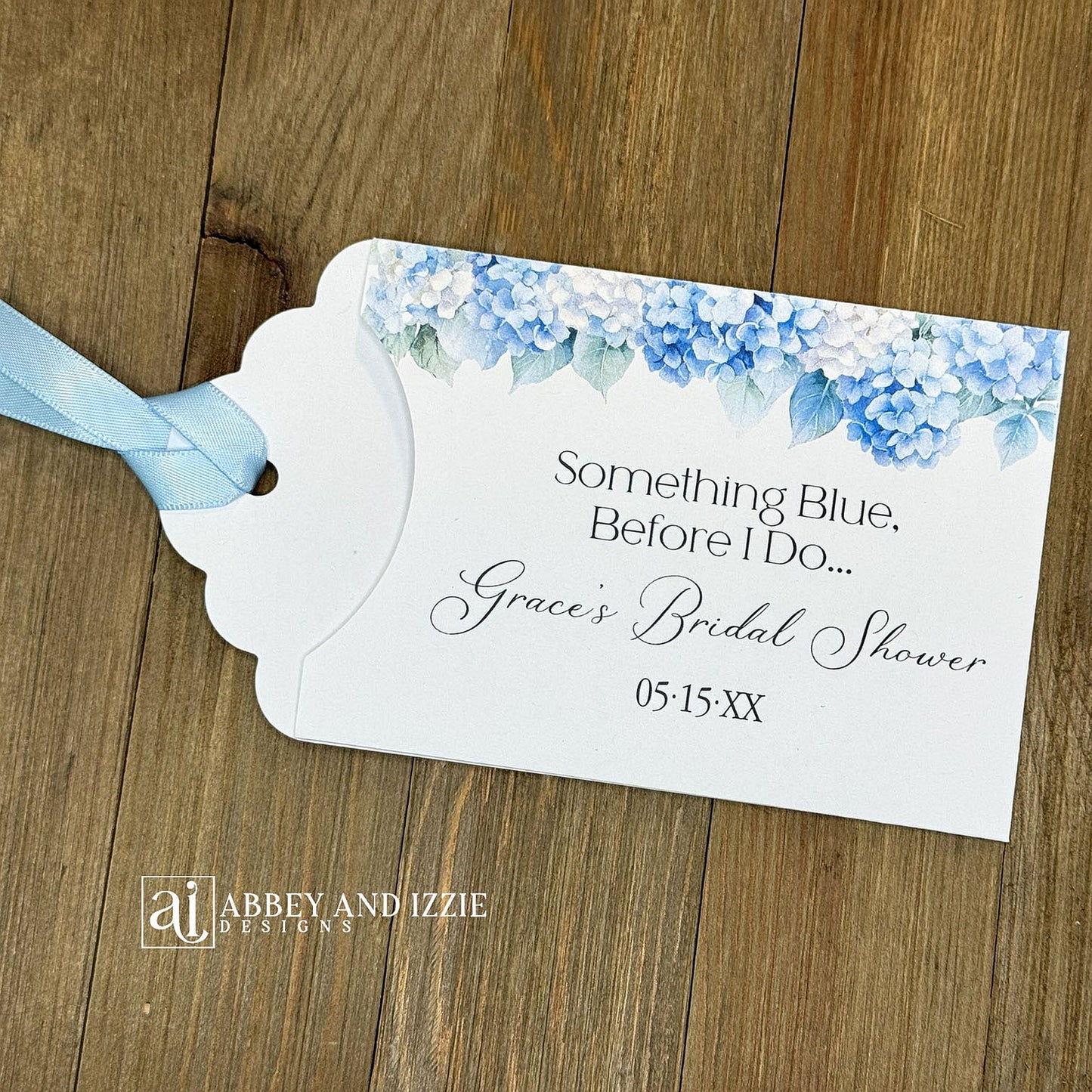 Celebrate the bride-to-be with our Something Blue Bridal Shower Favors—a charming way to honor tradition while delighting your guests. Each favor features beautiful blue hydrangeas, perfect for that 'something blue before I say I do theme'. Personalize with name and date to create a keepsake your guests will treasure. Slide a scratch off card in the open end to add some excitement to the event. Printed on sturdy white card stock with blue ribbon attached. Ideal for adding an elegant touch.