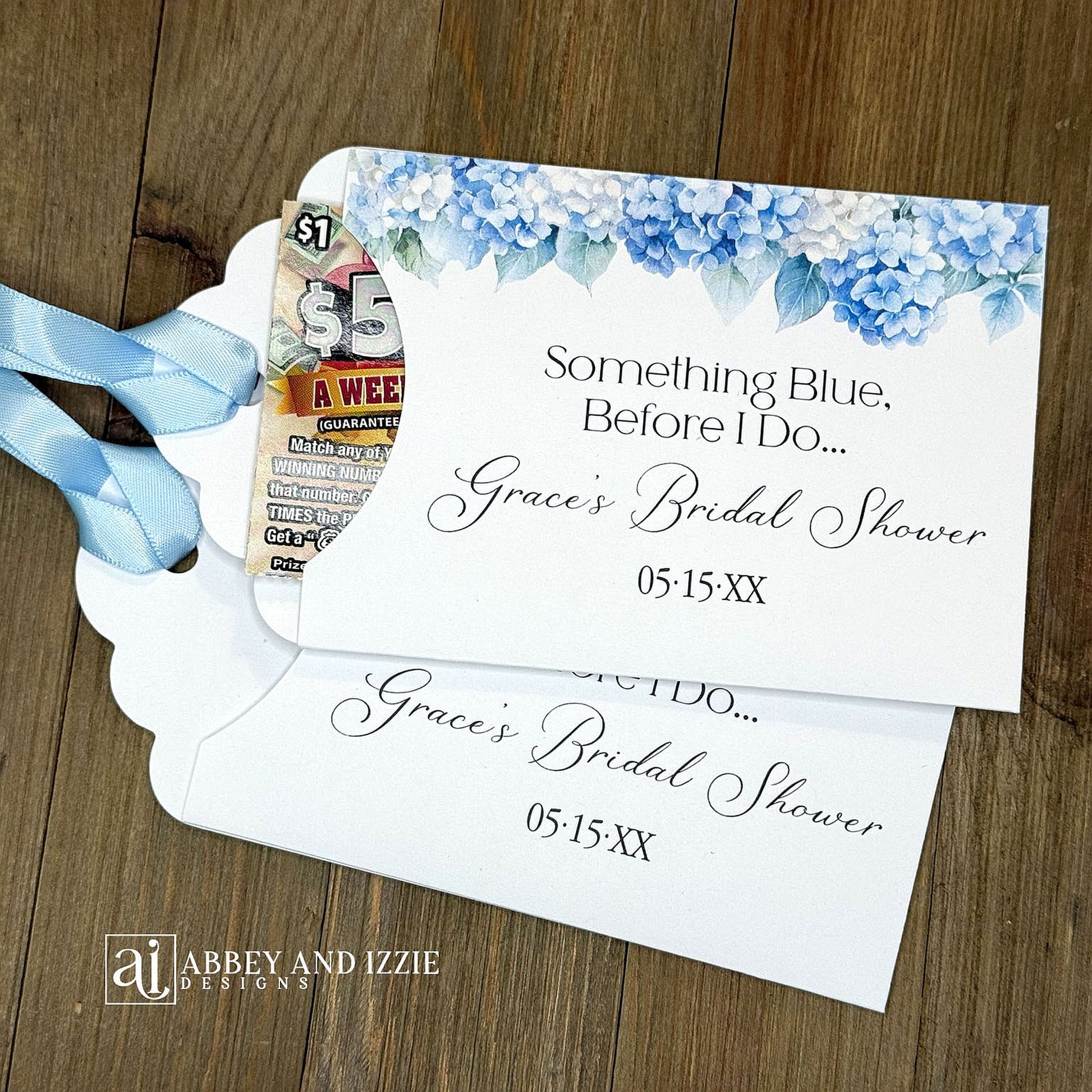 Celebrate the bride-to-be with our Something Blue Bridal Shower Favors—a charming way to honor tradition while delighting your guests. Each favor features beautiful blue hydrangeas, perfect for that 'something blue before I say I do theme'. Personalize with name and date to create a keepsake your guests will treasure. Slide a scratch off card in the open end to add some excitement to the event. Printed on sturdy white card stock with blue ribbon attached. Ideal for adding an elegant touch.
