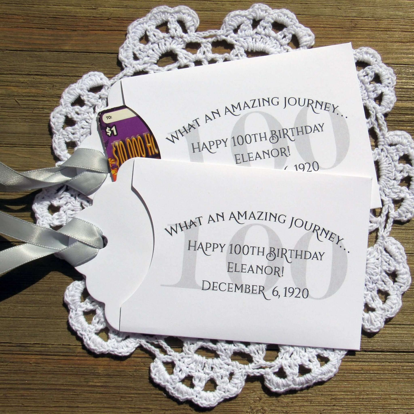 These 100th Birthday Party Favors Personalized  for the honoree with name and birthdate.  Each envelope is printed on white card stock with your choice of colors to match your party theme.  Ribbon comes attached, slide a lottery ticket in the open end and see which guest wins.