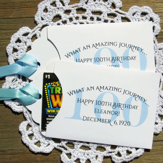 These 100th Birthday Party Favors Personalized  for the honoree with name and birthdate.  Each envelope is printed on white card stock with your choice of colors to match your party theme.  Ribbon comes attached, slide a lottery ticket in the open end and see which guest wins.