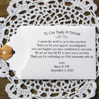 50th wedding anniversary party favors, personalized with a sweet saying to let your friends and family know how much they mean to you. Printed on white envelopes with a gold ribbon attached.