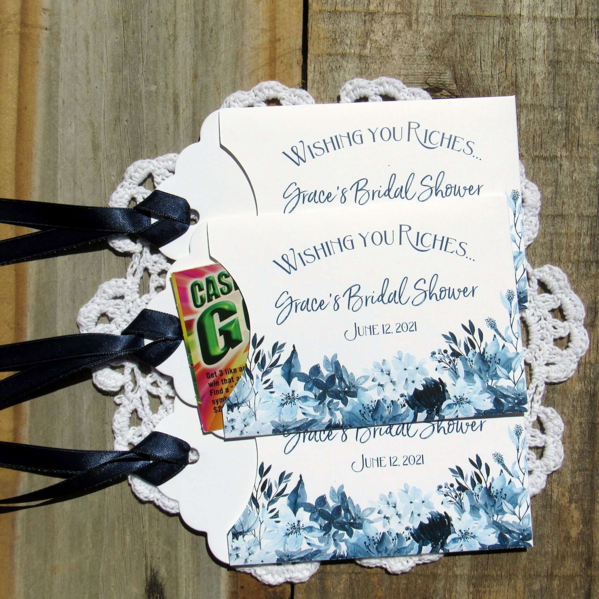 Navy Blue Bridal Shower Favors, personalized for the bride to be.  Small white envelopes adorned with navy flowers printed and a navy ribbon.  Slide a lotto ticket in for a fun bridal shower favor. 