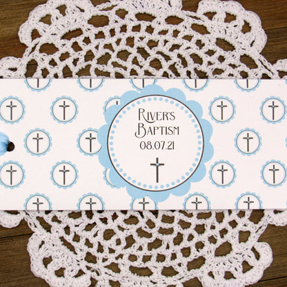 Personalized Baptism Party Favors for Baby Boys.  Printed on white card stock adorned with blue crosses with babies name and baptism date.  Choice of light blue or white ribbon which is included and left off for easy filling.  Slide a candy bar in the open end and tie the ribbon.