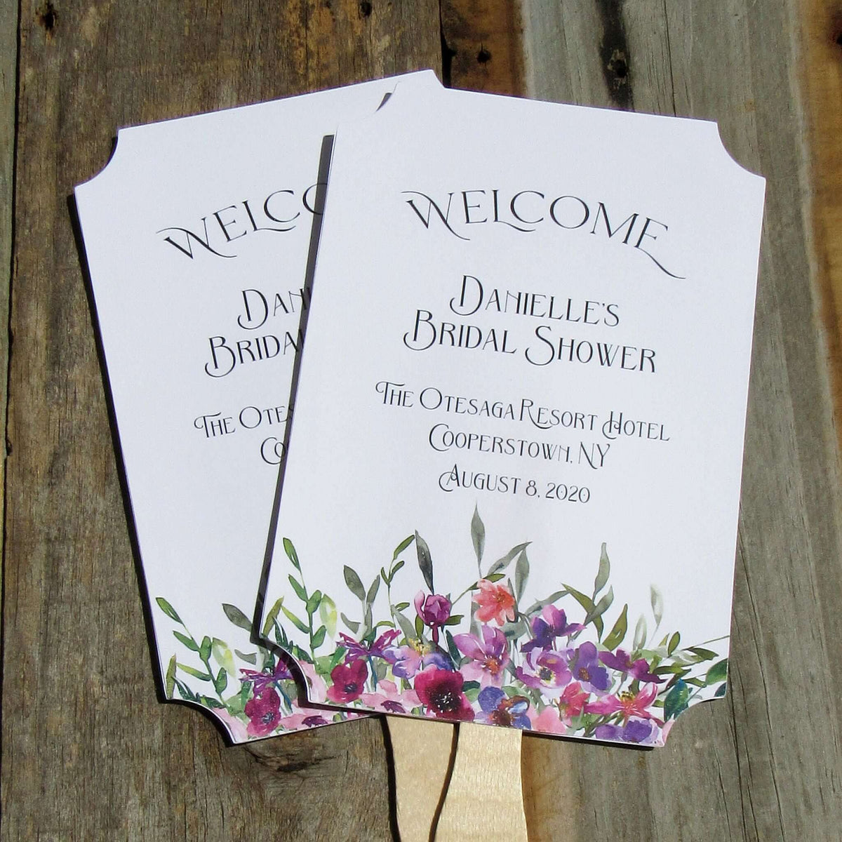 Bridal Shower Favor Fans Personalized, printed on white card stock and adorned with purple flowers.  Such a welcome favor on a warm summer day and a nice keepsake for everyone to take home.