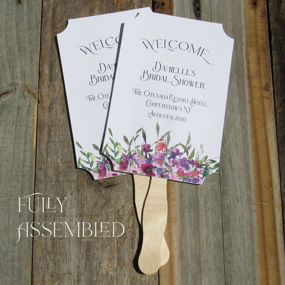 Bridal Shower Favor Fans Personalized, printed on white card stock and adorned with purple flowers.  Such a welcome favor on a warm summer day and a nice keepsake for everyone to take home.