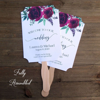 Burgundy Personalized Wedding Fans with the bride and grooms name and wedding date.  Printed on white card stock, two side with handle hidden between, printing on one side only.  Shipped to you assembled and ready for your special day.
