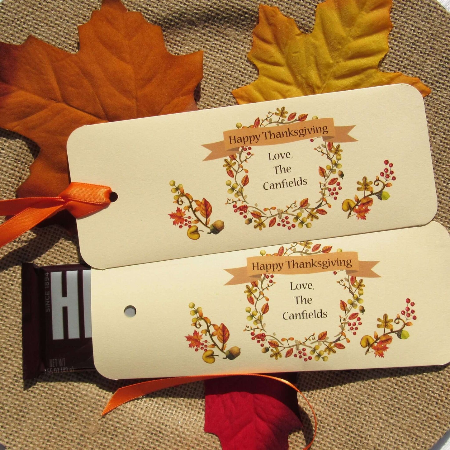 Thanksgiving Table Candy Favors that are personalized for a elegant touch.  Constructed from ivory card stock, these are sturdy candy bar favors, just slide the candy bar in the open end and tie the ribbon on.  