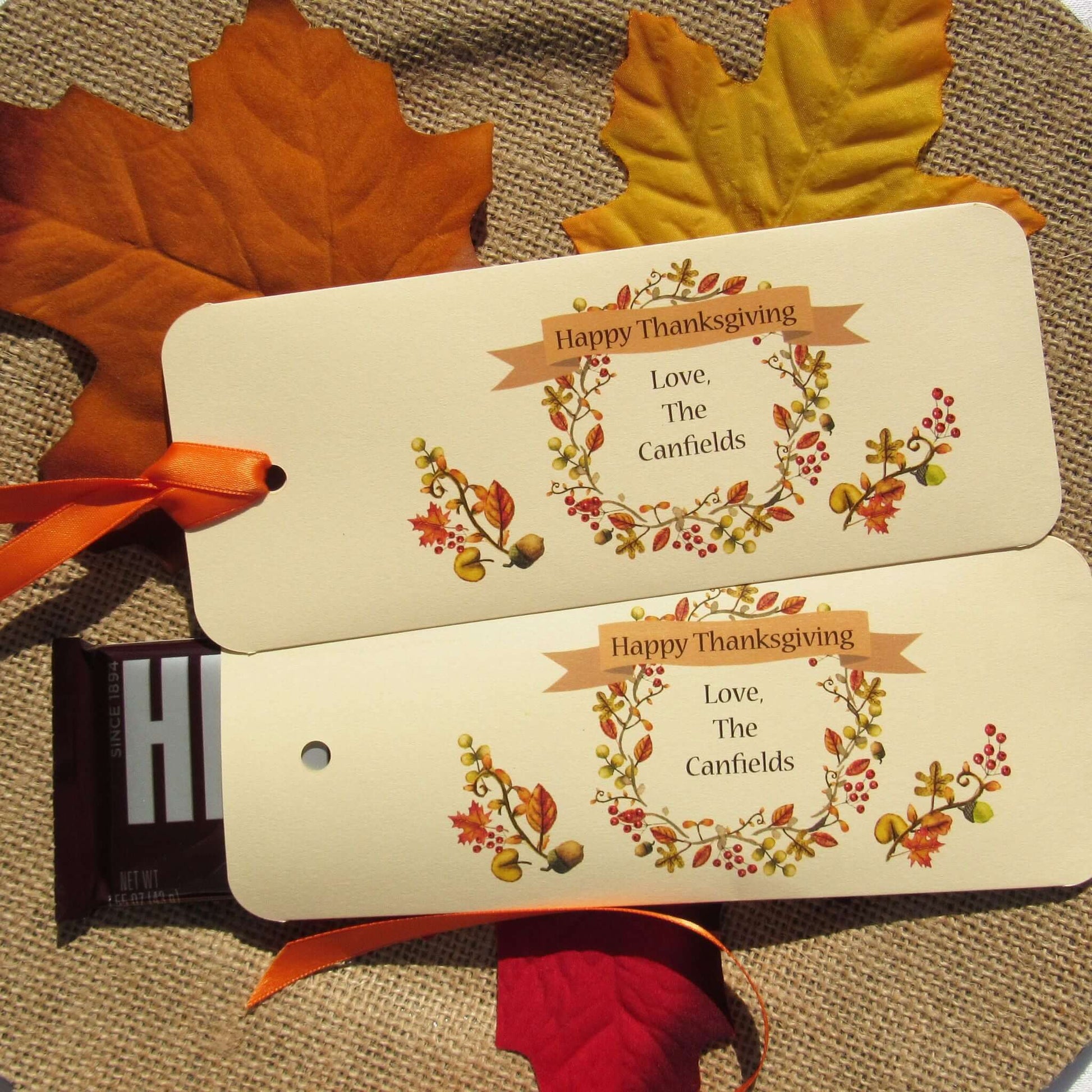 Thanksgiving Table Candy Favors that are personalized for a elegant touch.  Constructed from ivory card stock, these are sturdy candy bar favors, just slide the candy bar in the open end and tie the ribbon on.  