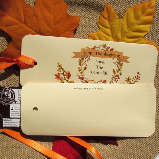 Thanksgiving Table Candy Favors that are personalized for a elegant touch.  Constructed from ivory card stock, these are sturdy candy bar favors, just slide the candy bar in the open end and tie the ribbon on.  