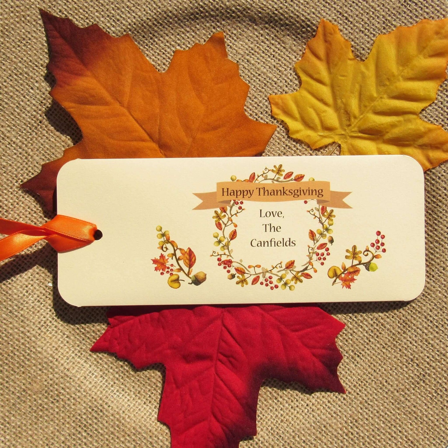 Thanksgiving Table Candy Favors that are personalized for a elegant touch.  Constructed from ivory card stock, these are sturdy candy bar favors, just slide the candy bar in the open end and tie the ribbon on.  