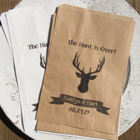Personalized rustic wedding favor bags adorned with a deer head,