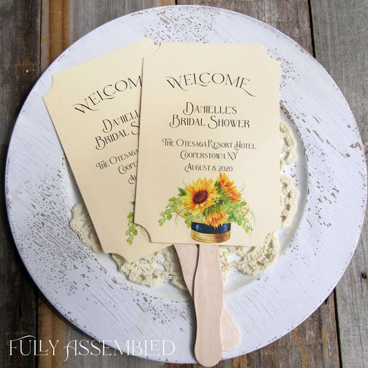 Sunflower Bridal Shower Favor Fans personalized for the bride to be.  Fans are printed on ivory cardstock adornerd with a beautiful sunflower motif.  Shipped to you assembled and ready for your event.  Fans have a wooden handle and are two sided with handle hidden, printing on one side only.