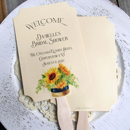 Sunflower Bridal Shower Favor Fans personalized for the bride to be.  Fans are printed on ivory cardstock adornerd with a beautiful sunflower motif.  Shipped to you assembled and ready for your event.  Fans have a wooden handle and are two sided with handle hidden, printing on one side only.