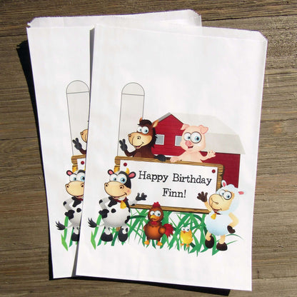 Farm Theme Birthday Party Goodie Bags personalized for the guest of honor.  Printed on white bags, adorned with cute farm animals.  Fill these goodie bags with candy, cookies, popcorn or fun favors.
