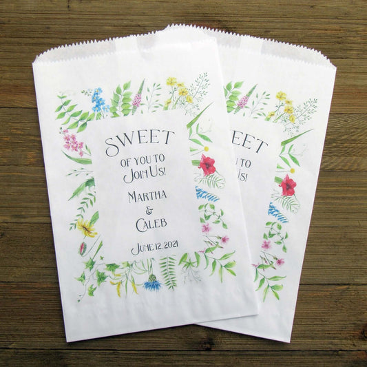 Floral Wedding Candy or Cookie Bags, personalized for the bride and groom.  Printed on white bags with a floral frame around the text.  These bags are larger than most, more room for guests to take home some sweet treats. 