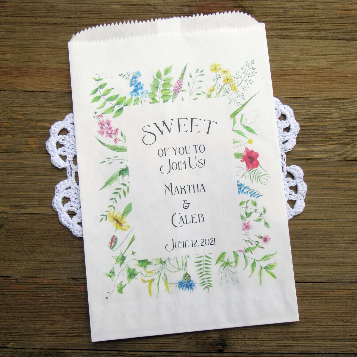 Floral Wedding Candy or Cookie Bags, personalized for the bride and groom.  Printed on white bags with a floral frame around the text.  These bags are larger than most, more room for guests to take home some sweet treats. 
