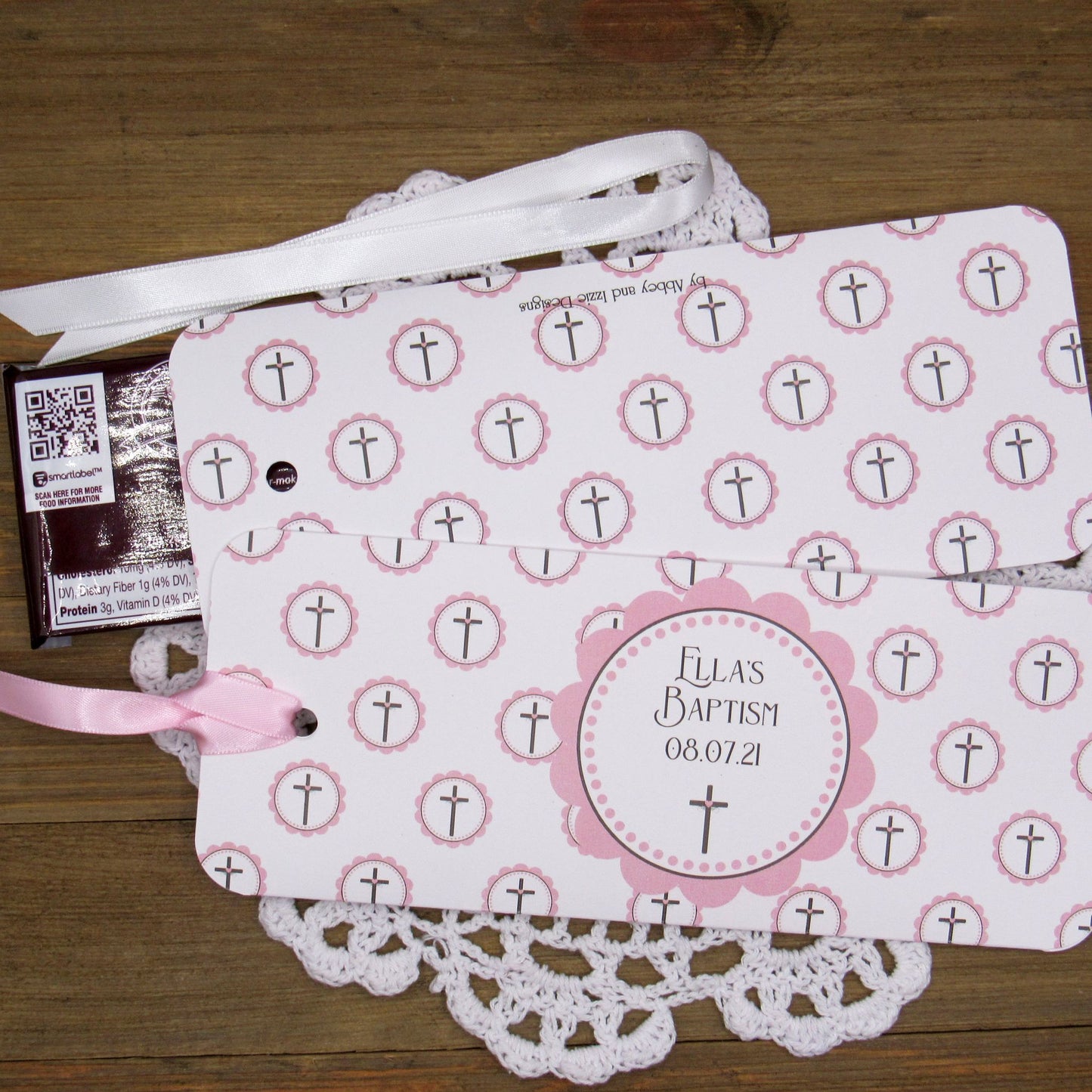 Personalized Baptism Favors for Baby Girls, slide a candy bar in these holders for a personalized guest favor.  Printed on white card stock, adorned with pink crosses, white or pink ribbon which is included.