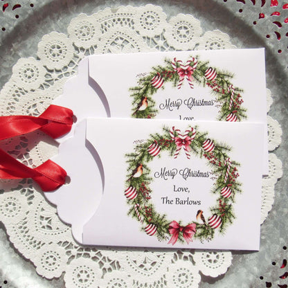 Personalized Christmas Party Favors Affordable Gifts, adorned with a beautiful wreath and a red ribbon attached.  These can be used for lottery ticket favors or gift card holders.