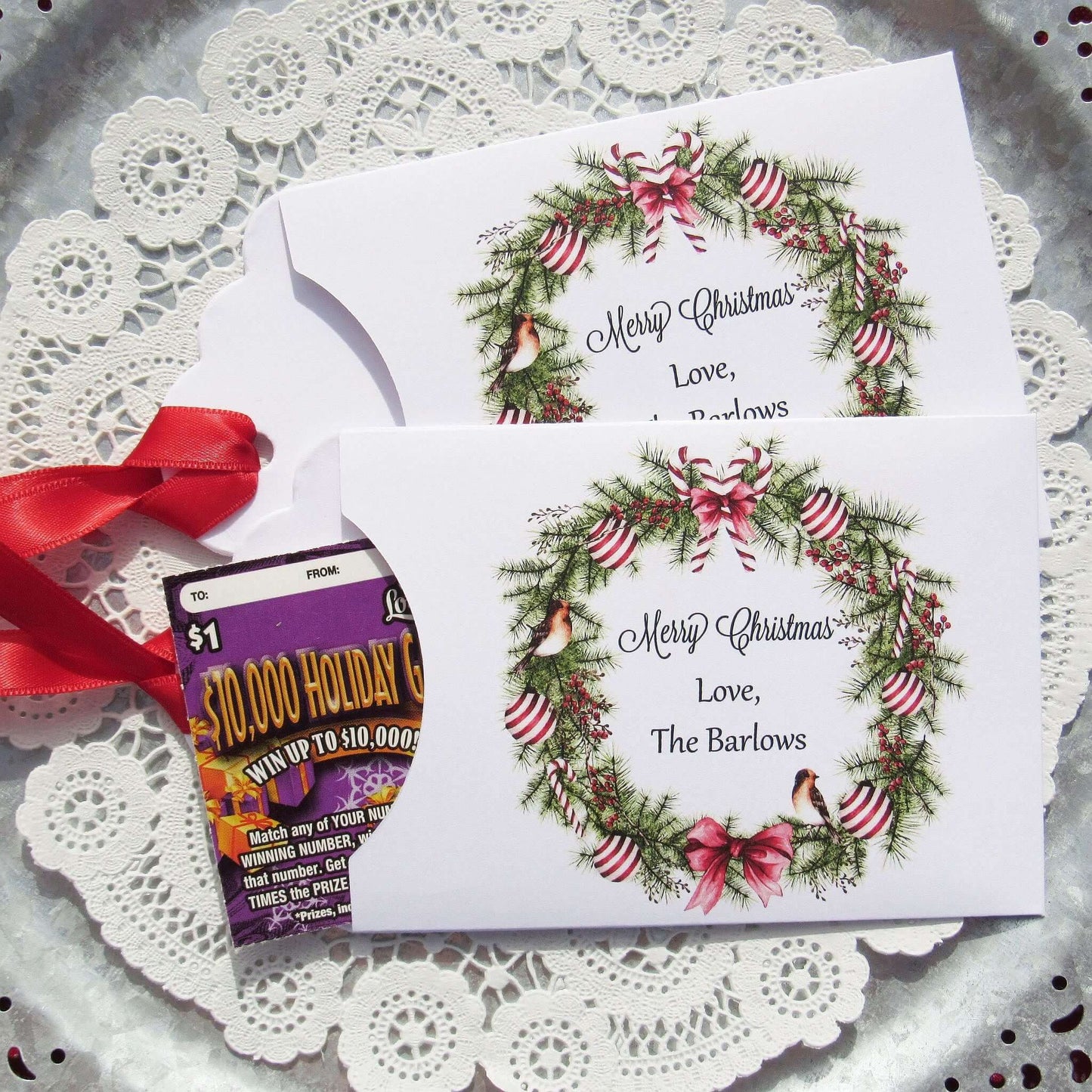 Personalized Christmas Party Favors Affordable Gifts, adorned with a beautiful wreath and a red ribbon attached.  These can be used for lottery ticket favors or gift card holders.