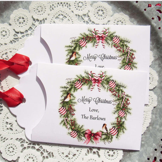 Personalized Christmas Party Favors Affordable Gifts, adorned with a beautiful wreath and a red ribbon attached.  These can be used for lottery ticket favors or gift card holders.