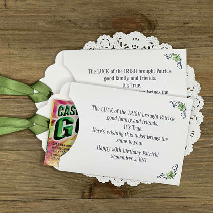 Irish Birthday Party Favors printed with 'the luck of the Irish' and the honoree name and birth date.  Lottery ticket envelopes printed on white card stock adorned with a green ribbon and shamrocks.  