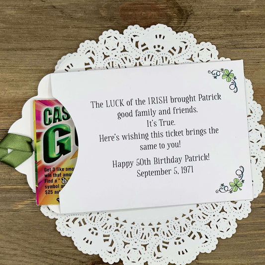 Irish Birthday Party Favors printed with 'the luck of the Irish' and the honoree name and birth date.  Lottery ticket envelopes printed on white card stock adorned with a green ribbon and shamrocks.  